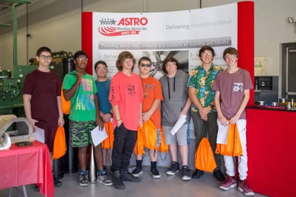 Students smiling for picture at Astro Machine Work's National Manufacturing Day celebration