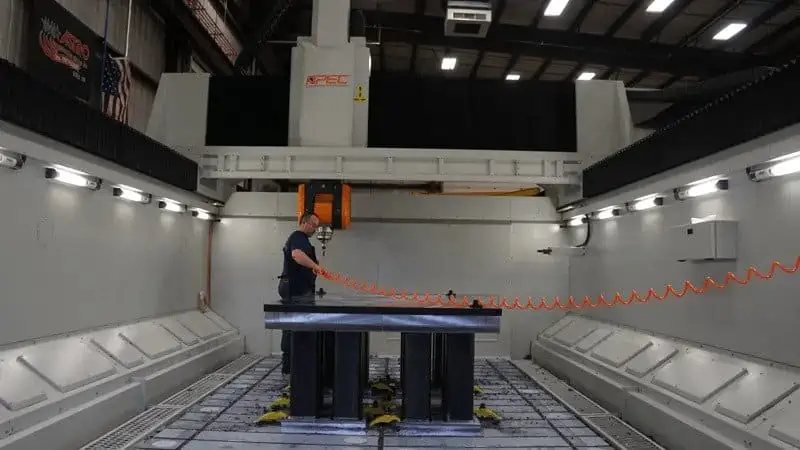 Astro Employee Operating 5-Axis Machine