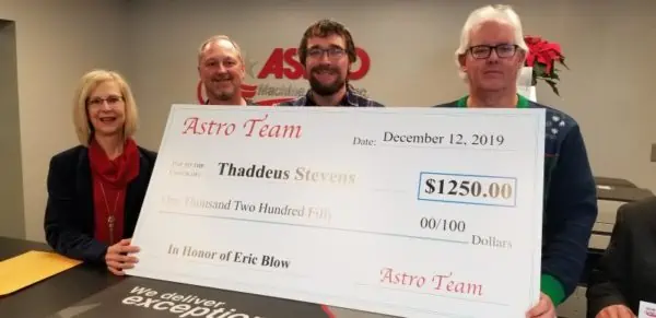 Brian Paul presenting Astro CEO Eric Blow with a 1250 dollar scholarship