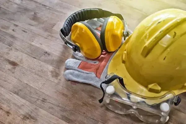 Hardhat, earmuffs, and safety glasses sitting next to each other
