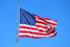 American flag on flagpole blowing in the wind